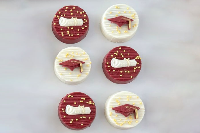 Array of cake pops decorated with Graduation designs